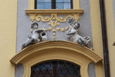 DURNSTEIN, AUSTRIA - MAY 13, 2019: These are Baroque decorations of one of the entrances to the cloister of Durnstein Abbey in the form of allegorical figures of Water and Fire.