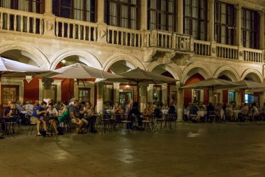 SIBENIK, CROATIA - SEPTEMBER 9, 2016: Unidentified vacationers rest in a night cafe in the historic center of the city.