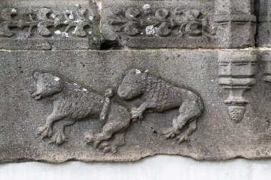FUNCHAL, PORTUGAL - AUGUST 25, 2021: This is a fragment of an old stone carving on a window frame in the architectural park of the Quinta das Cruzes estate.