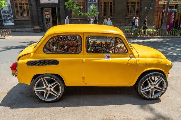 Yerevan Armenia April 2022 Bright Yellow Car Filled Small Dolls — стоковое фото