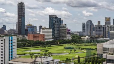 Bangkok, Thailand - 10 August 2022 - Time lapse view of Bangkok cityscape with high-rise buildings and BTS skytrains