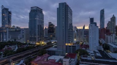 Bangkok, Thailand - 10 August 2022 - Time lapse view of Bangkok cityscape with high-rise buildings and BTS skytrains