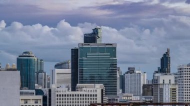 Bangkok, Thailand - 10 August 2022 - Time lapse view of Bangkok cityscape with high-rise buildings and BTS skytrains