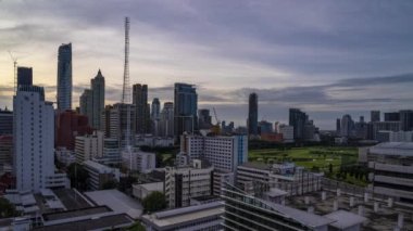 Bangkok, Thailand - 10 August 2022 - Time lapse view of Bangkok cityscape with high-rise buildings and BTS skytrains