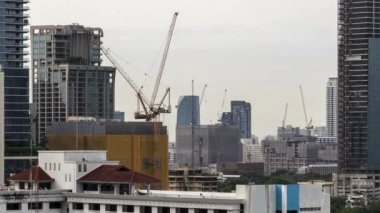 Bangkok, Thailand - 10 August 2022 - Time lapse view of Bangkok cityscape with high-rise buildings and construction cranes