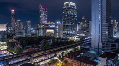 Bangkok, Thailand - 10 August 2022 - Night view of Bangkok cityscape with high-rise buildings and BTS skytrains