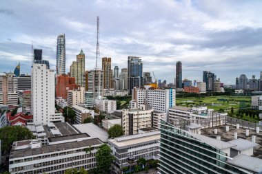 Bangkok, Thailand - 10 August 2022 - Aerial view of Bangkok cityscape showing high-rises with cloudy blue sky