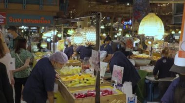 Bangkok, Thailand - 10 August 2022 - Shoppers and vendors buy and sell food at the food market in Icon Siam food hall in Bangkok, Thailand