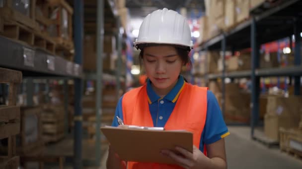 Happy Young Female Warehouse Staff Wearing Safety Vest Hardhat Looking — Wideo stockowe
