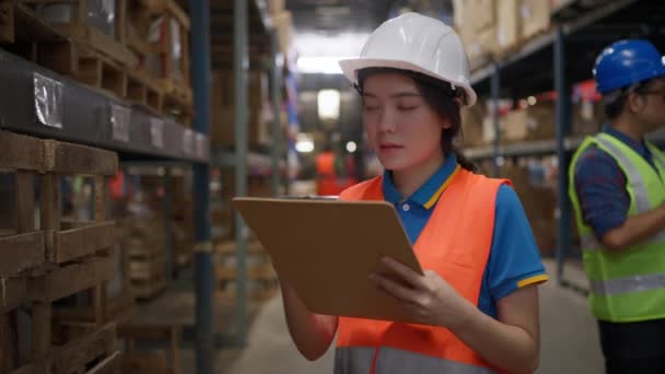 Young Female Warehouse Staff Wearing Safety Vest Hard Hat Holding — Stock video
