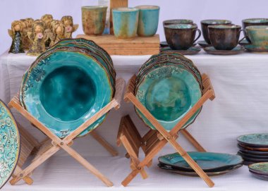 Magdeburg, Pottery Market - August 06, 2022: Handmade ceramic tableware. Individual household ceramics, cheerful ceramics, exquisite jewelry, art objects