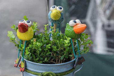 Magdeburg, Pottery market - August 06, 2022: Handmade fancy birds for flowers pots. Sale of Individual utility ceramics, fun pottery, fine jewelry to artistic objects of German masters