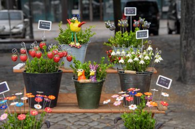 Magdeburg, Pottery market - August 06, 2022: Handmade fancy ceramic flowers. Sale of Individual utility ceramics, fun pottery, fine jewelry to artistic objects of German masters