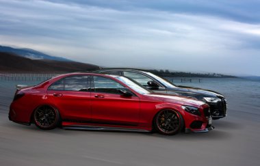Red and black cars on a natural background.