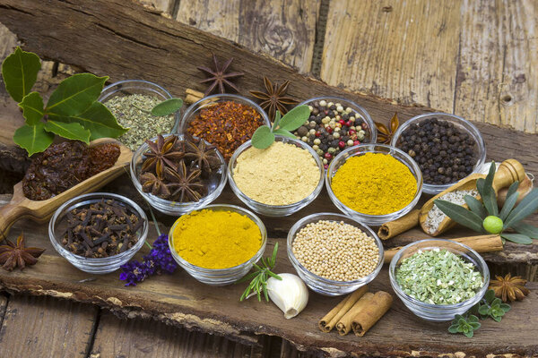 Variety of spices on old wooden background