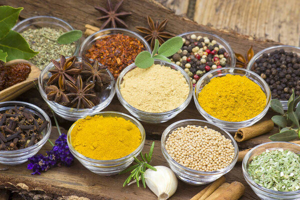 Variety of spices on wooden background