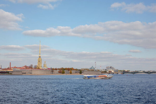View from the Spit of Vasilivsky Island to the Peter and Paul Fortress. Pleasure boat for tourists.