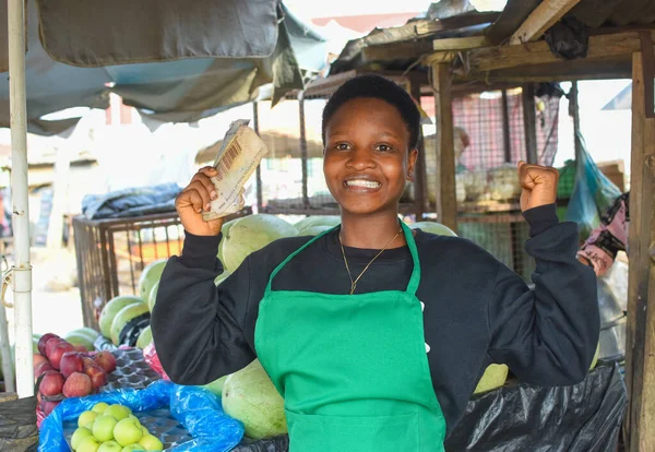 Happy African Woman Female Trader Green Apron Holding Some Naira — Fotografia de Stock