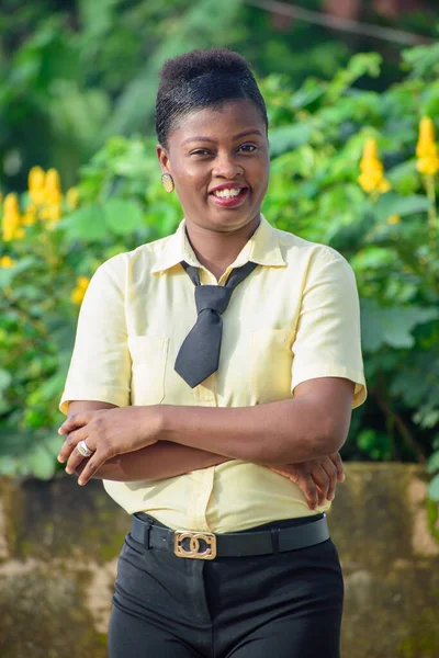 An African lady or woman dressed as a student or business person standing outdoor