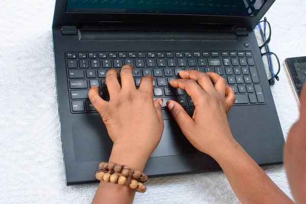 Female African hands  using laptop or computer by typing on the keyboard