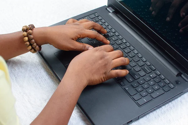 Female African hands  using laptop or computer by typing on the keyboard