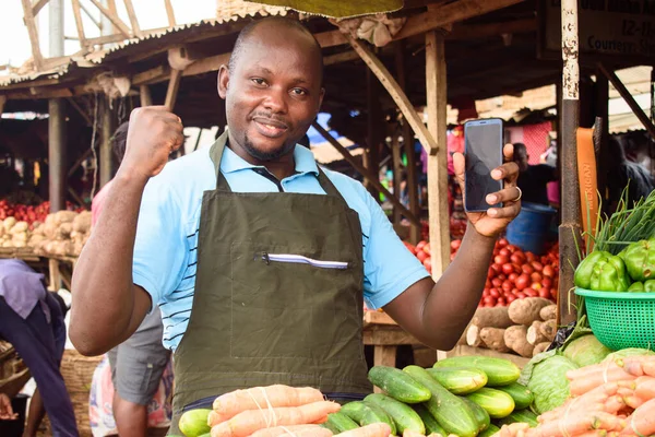 Stock Photo Happy Male African Grocery Seller Apron Smart Phone — Stockfoto