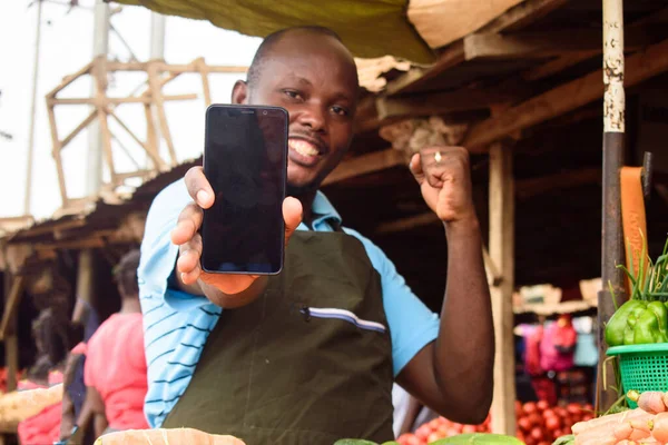 Stock Photo Happy Male African Grocery Seller Apron Smart Phone — Fotografie, imagine de stoc