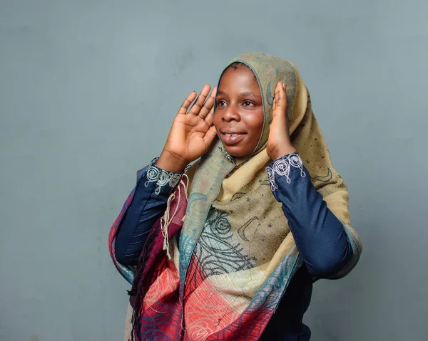 An African Nigerian female muslim lady with Hijab scarf, engaging the process of prayer or ablution which is more noticeable during ramadan and when going to mosque