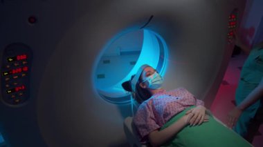Young dentist man with blue gloves and mask explain to her patient his result of teeth X-ray , showing to the man his problem , they have a nice conversation , smiling faces in a light dentist room