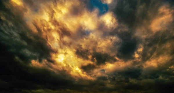 Beautiful stormy sunset sky. Storm clouds covered the sunset. Apocalyptic tragic sky