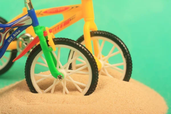 bike toy on green background ride fun children bike, toy, on green background, ride, fun, children,sand,beach ,play,summer,colorful,