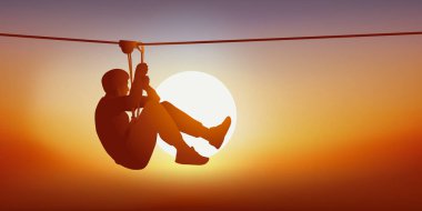 Concept of leisure and outdoor activities with a man looking for thrills on the zip line of a tree climbing course.
