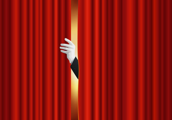Concept of show and entertainment, with a hand opening the red curtain of a theater stage.