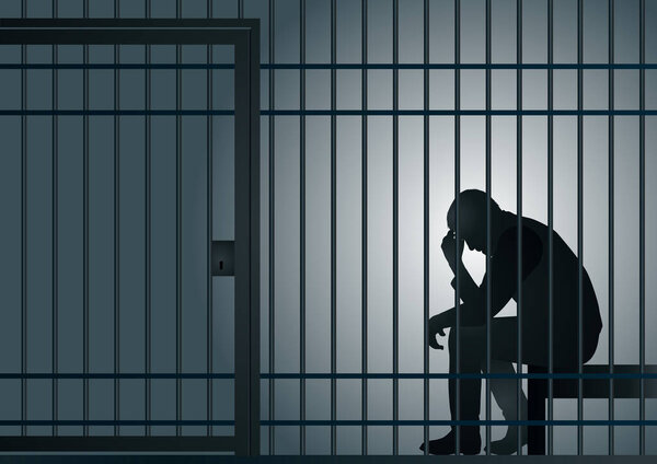 Concept of prison and deprivation of liberty with a prisoner reflecting on the consequences of his crime, behind bars in his cell.