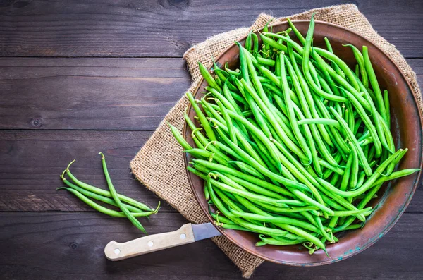 Green beans top view copy space background.