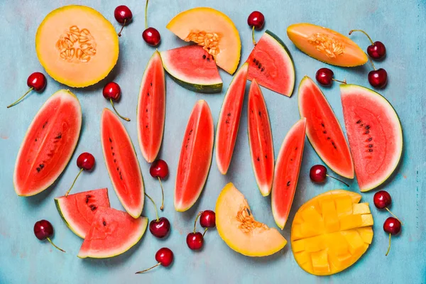 Summer fruits vibrant colors watermelon, cherries and melon fruits background.