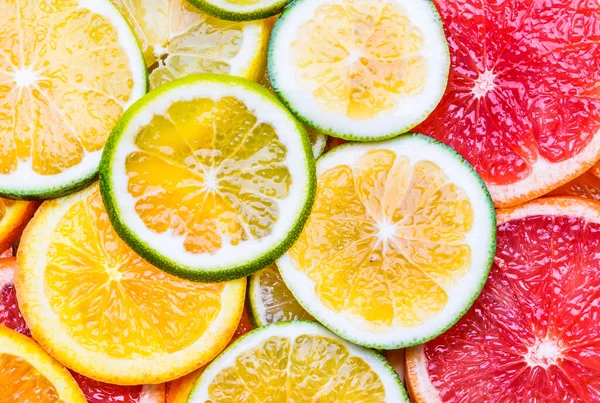 Citrus fruit variety background. Slices of lemon, orange, mandarin, lime, grapefruit background. Vitamin C fruits concept background.