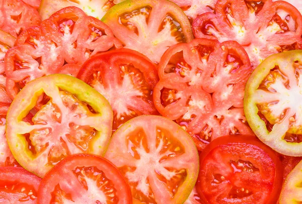 Tomatoes slices close up background.