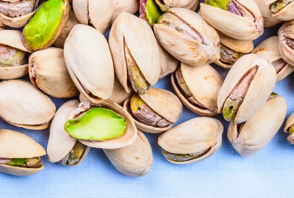 Pistachio nuts close up copy space background.