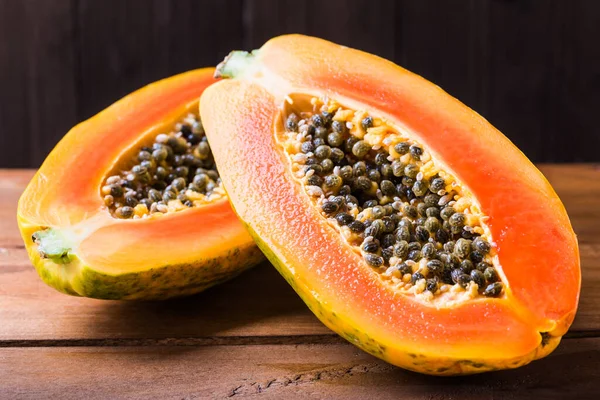 Papaya fruit on wooden background copy space.