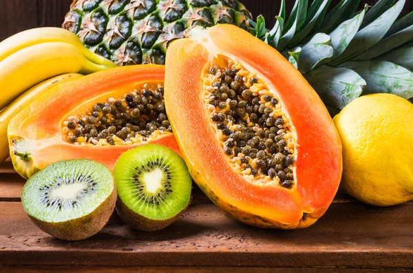 Fresh fruits tropical fruits papaya, pineapple, kiwi, bananas background.