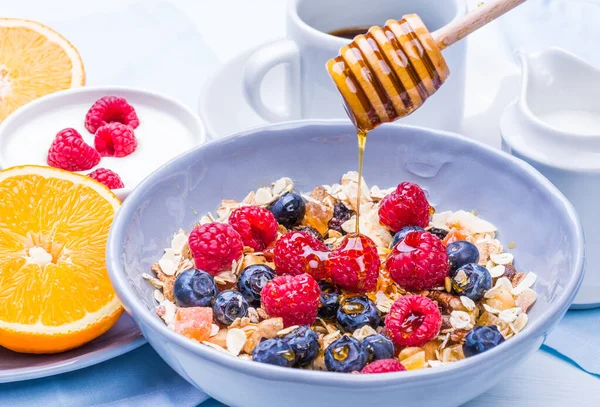 Breakfast bowl with cereals oats, berries and honey. Healthy breakfast.