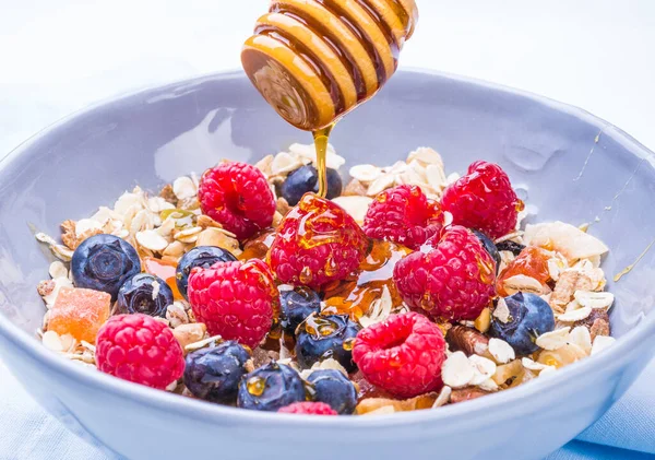 Healthy breakfast bowl with cereals oats and berries, fruits.