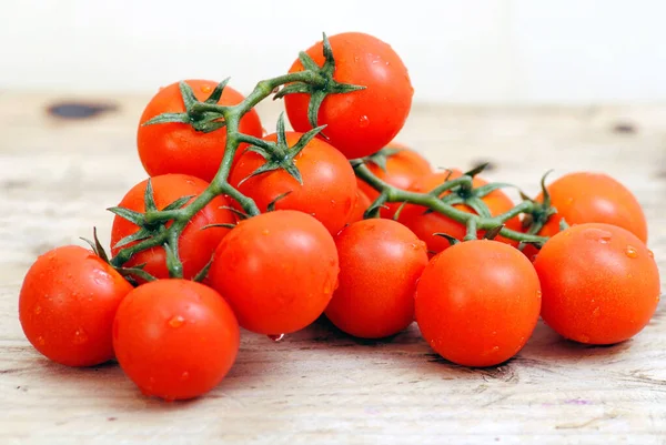 Tomatoes on wooden background copy space.