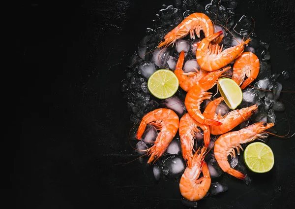 Shrimps cooked on dark black background copy space.