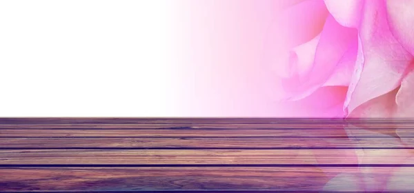 pink wooden table with purple flowers on a light background.
