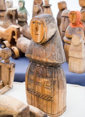 Sevastopol, Crimea - September 19, 2020: Carved from wood female amulet figurine clipart