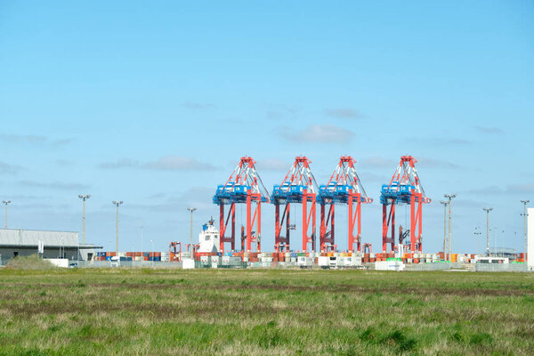 Container loading cranes at the industrial Jade Weser deep water port, cargo shipping ports in Germany.