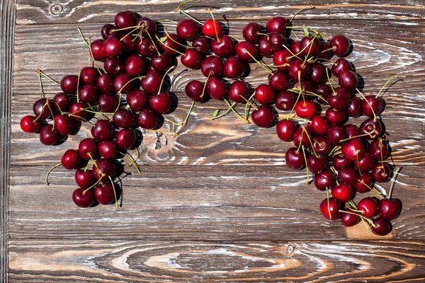 Many Ripe Red Cherries Twigs Lie Edge Wooden Table Striped — Stock Photo, Image