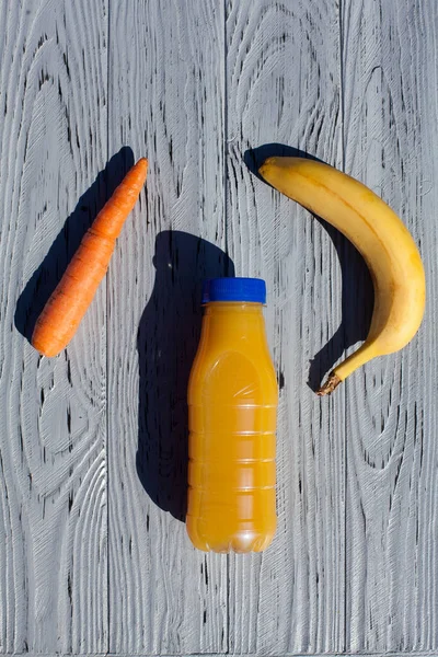 Appetizing Composition Bottle Orange Juice Banana Carrots Light Textured Wooden — ストック写真